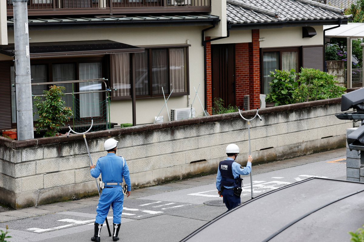Policemen with sticks shields search for a bear at a residential area after a black bear was spotted in Utsunomiya, Tochigi Prefecture, Japan, June 9, 2026. REUTERS/Kim Kyung-Hoon