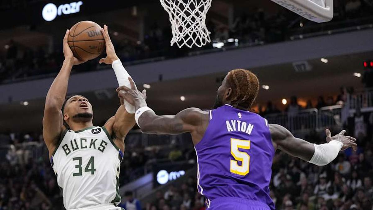  Nov 15, 2025; Milwaukee, Wisconsin, USA; Milwaukee Bucks forward Giannis Antetokounmpo (34) shoots against Los Angeles Lakers center Deandre Ayton (5) during the first quarter at Fiserv Forum. Mandatory Credit: Jeff Hanisch-Imagn Images | Jeff Hanisch-Imagn Images 