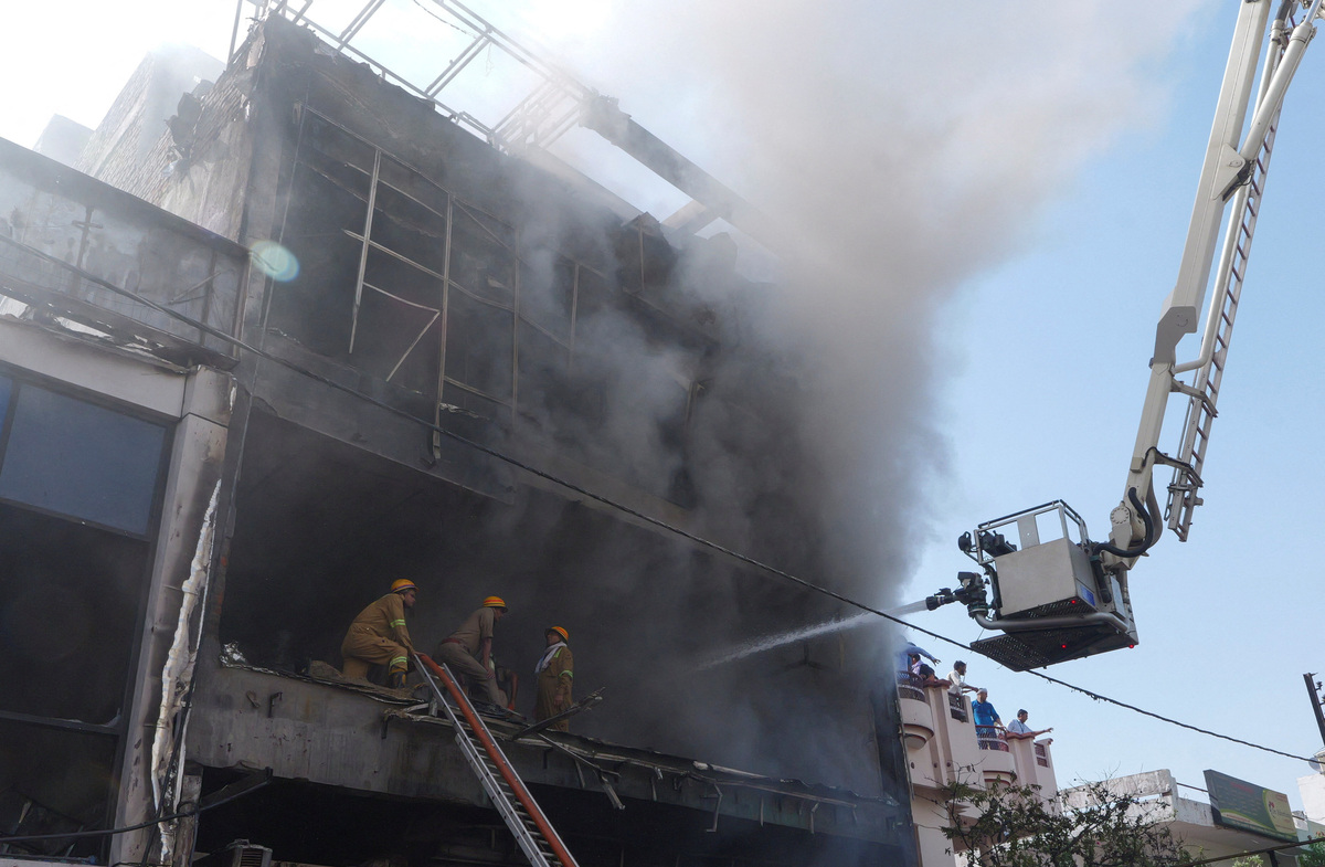 Firefighters douse a deadly fire at a coaching centre in Lucknow, India, June 22, 2026. REUTERS/STRINGER