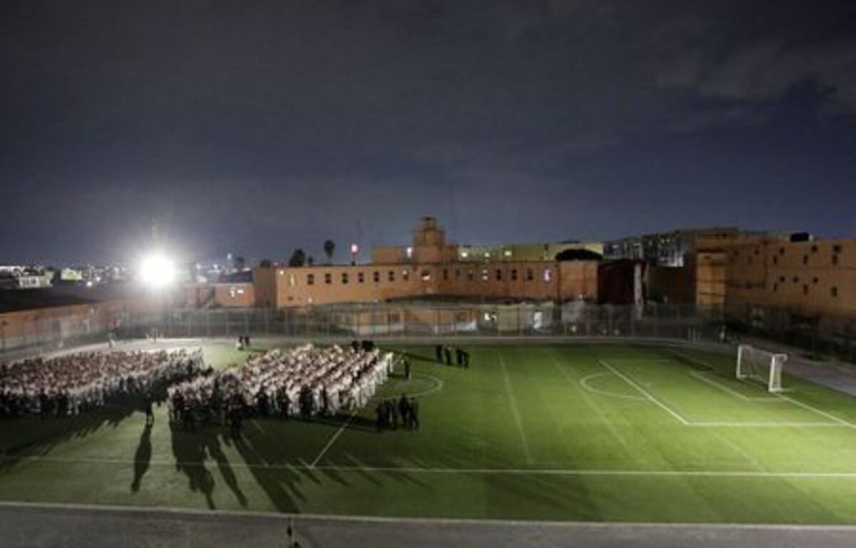 Inmates at Topo Chico Prison wait on a soccer field with their hands tied to be transferred to a new facility as part of the process of closing the prison and converting it into a public area, now known as Liberty Park, in Monterrey, Mexico, September 27, 2019. REUTERS/Daniel Becerril