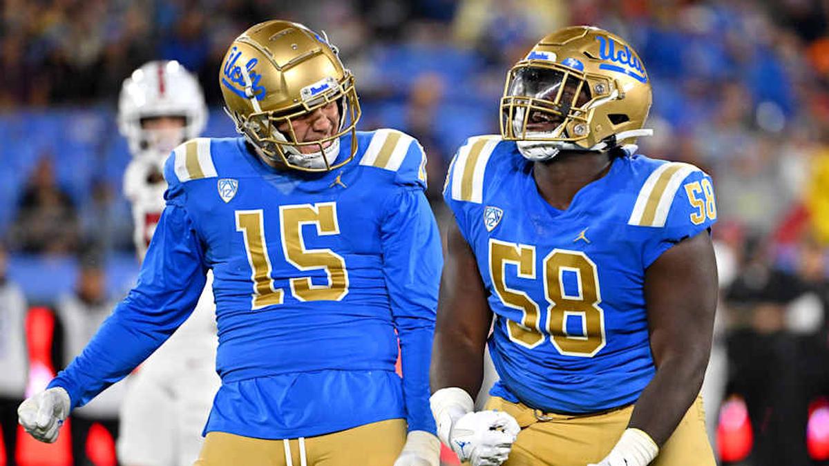  Oct 29, 2022; Pasadena, California, USA; UCLA Bruins linebacker Laiatu Latu (15) and defensive lineman Gary Smith III (58) celebrate after a sack of Stanford Cardinal quarterback Tanner McKee (18) in the first half at the Rose Bowl. Mandatory Credit: Jayne Kamin-Oncea-Imagn Images | Jayne Kamin-Oncea-Imagn Images 