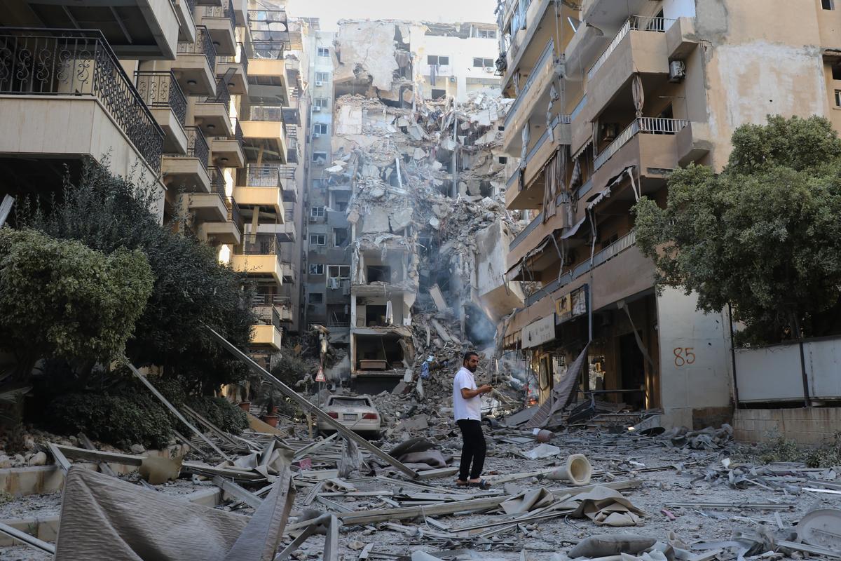  A man checks the site of destroyed buildings that were hit in Israeli airstrikes in the southern port city of Tyre, Lebanon, on May 28, 2026. 