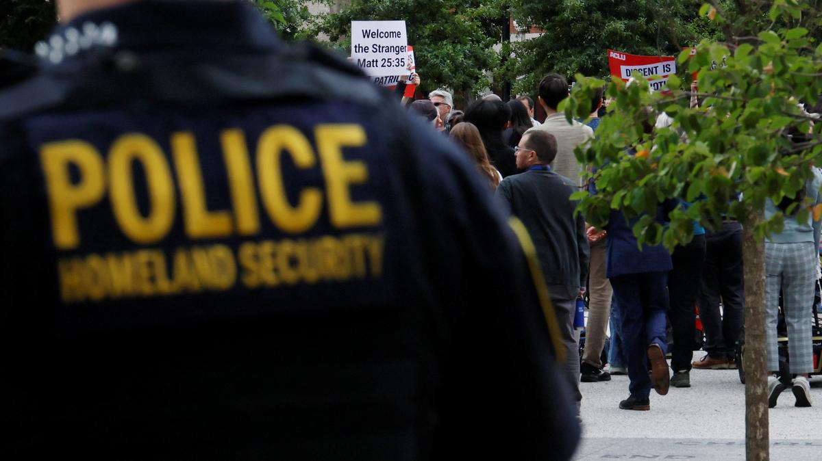 Homeland Security police officer stands behind a press conference called by Boston Mayor Michelle Wu to respond to a letter from U.S. Attorney General Pam Bondi demanding that Boston lift its sanctuary city policies, in Boston, Massachusetts, U.S., August 19, 2025.  A sanctuary city is a jurisdiction that has laws and policies that limit or prevent local law enforcement from assisting federal officers with civil immigration arrests. REUTERS/Brian Snyder