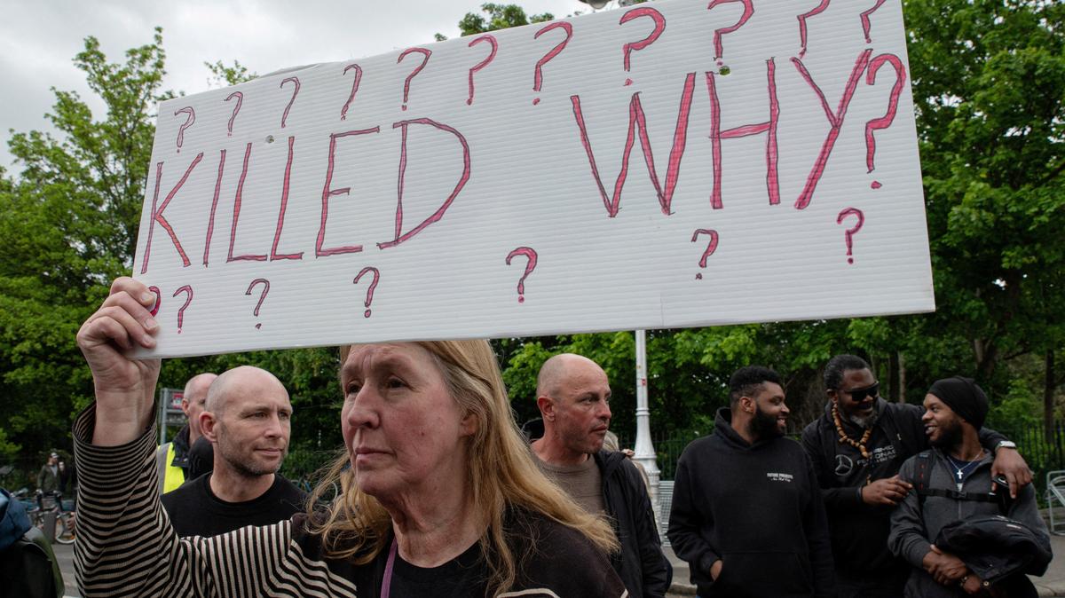 People hold placards during a protest following the death of Yves Sakila, a Congolese-born man who died after being restrained by security guards outside a department store, outside Leinster House in Dublin, Ireland, May 21, 2026. REUTERS/Natalia Campos
