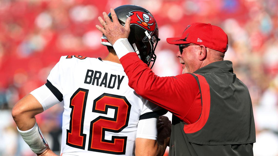 FILE - Tampa Bay Buccaneers head coach Bruce Arians talks to quarterback Tom Brady (12) before an NFL football game against the Carolina Panthers, Sunday, Jan. 9, 2022, in Tampa, Fla. Despite reports that he is retiring, Brady has told the Tampa Bay Buccaneers he hasn’t made up his mind, two people familiar with the details told The Associated Press, Saturday, Jan. 29, 2022. (AP Photo/Mark LoMoglio, File)