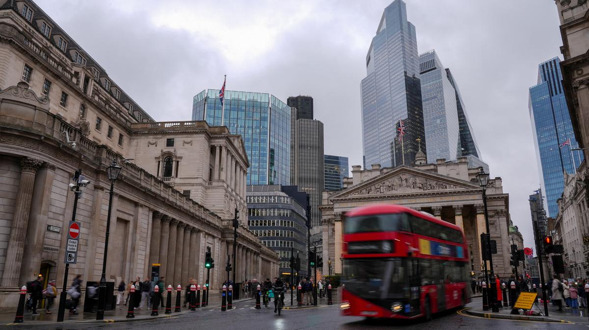 People walk near the Bank of England building in London, Britain, December 1, 2025. REUTERS/Maja Smiejkowska