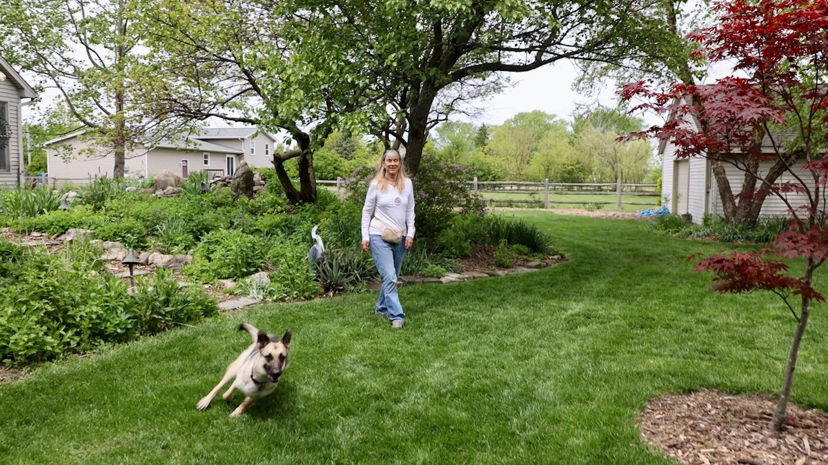 Christine Coultrip plays with her dog in her backyard in Perrysburg, Ohio, on May 12. Coultrip worries she will lose her home amid rumors of a new hyperscale data center in her town.