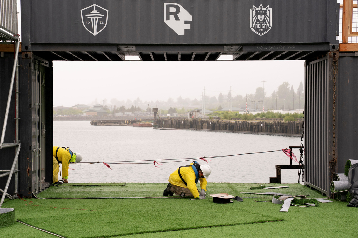 Workers construct a floating pitch and event space on a barge, dubbed the Seattle Soccer Celebration, which will be home to watch parties and events organized and hosted by Seattle Sounders FC, Seattle Reign FC, and RAVE Foundation while located on the Seattle waterfront during the FIFA World Cup 2026, in Everett, Washington, U.S., June 4, 2026. REUTERS/David Ryder