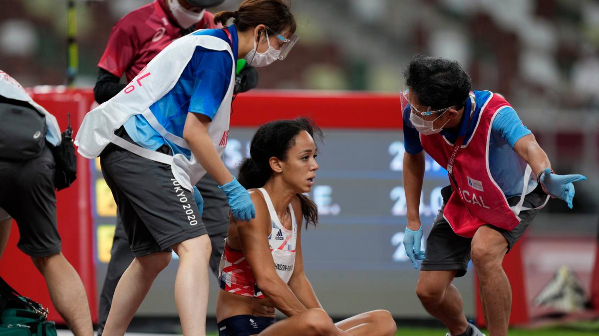 Katarina Johnson-Thompson, of Britain, reacts after falling during a heat in the heptathlon women’s 200-meter at the 2020 Summer Olympics, Wednesday, Aug. 4, 2021, in Tokyo. (AP Photo/Martin Meissner)