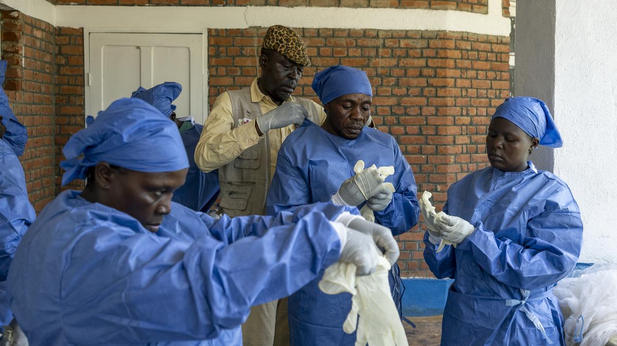 Health workers prepare to handle the corpse of a person thought to have died of Ebola, in Mongbwalu, Democratic Republic of Congo, May 24. (Arlette Bashizi/The New York Times)