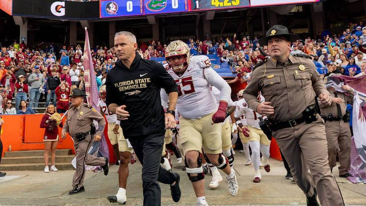  Nov 29, 2025; Gainesville, Florida, USA; Florida State Seminoles head coach Mike Norvell leads his team onto the field before the game against the Florida Gators at Ben Hill Griffin Stadium. Mandatory Credit: Bob Kupbens-Imagn Images | Bob Kupbens-Imagn Images 