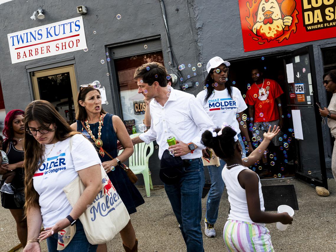 Chaz Molder, the mayor of Columbia and a Democratic House candidate, center, with his wife, Elizabeth Molder, during the town's annual Mule Day celebrations in Columbia, Tenn., April 11, 2026. Molder, a small-town mayor and turkey hunter with a penchant for retail politics, is one of several Democrats hoping that a focus on kitchen-table issues can reverse their party's fortunes in places like rural Tennessee. (Brad J. Vest/The New York Times)