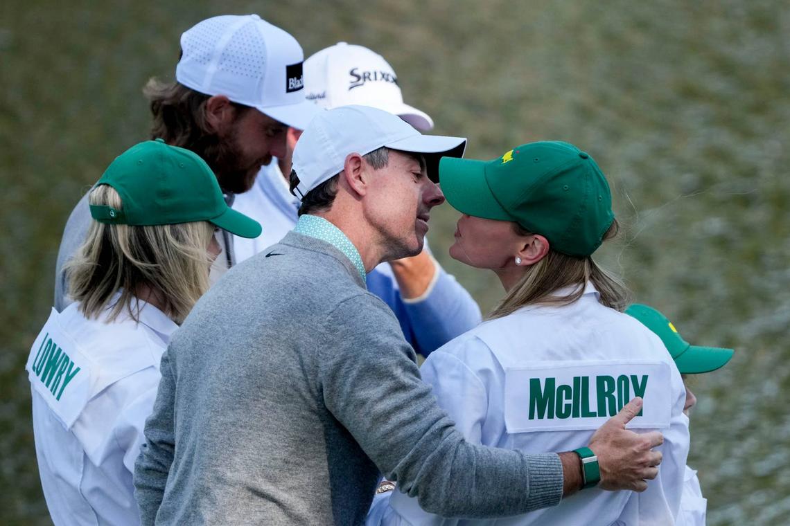  Apr 8, 2026; Augusta, Georgia, USA; Rory McIlroy leans in to kiss his wife, Erica Stoll, on the ninth green during the Par 3 Contest at the Masters Tournament at Augusta National Golf Club. Mandatory Credit: Kyle Terada-Imagn Images 