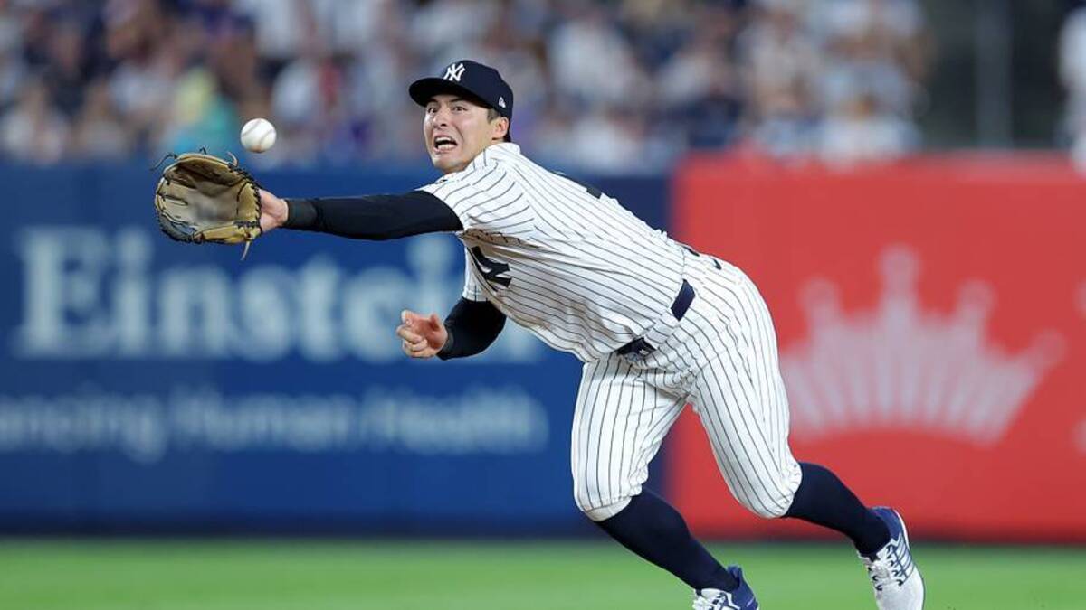  New York Yankees shortstop Anthony Volpe (11) can't catch a throw from second baseman Jose Caballero (not pictured) on a ground ball by Detroit Tigers shortstop Zach McKinstry (not pictured) allowing Tigers first baseman Spencer Torkelson (not pictured) to advance from first to third base during the sixth inning at Yankee Stadium. | IMAGN IMAGES via Reuters Connect 