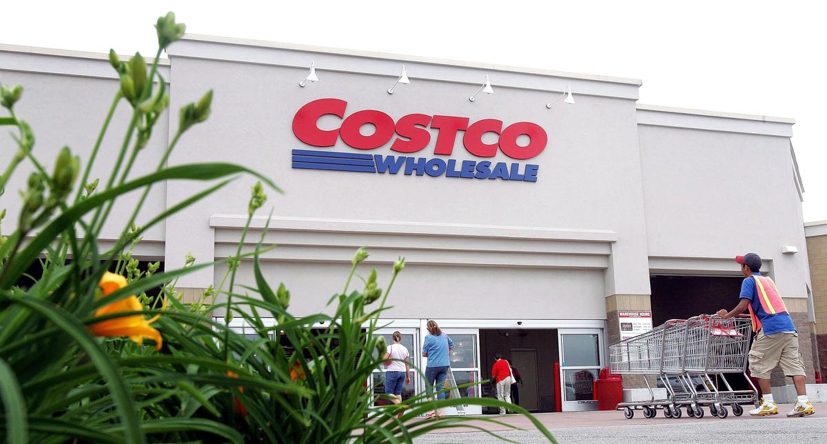 MOUNT PROSPECT, IL - MAY 31:  A worker pushes carts outside a Costco Wholesale store.
