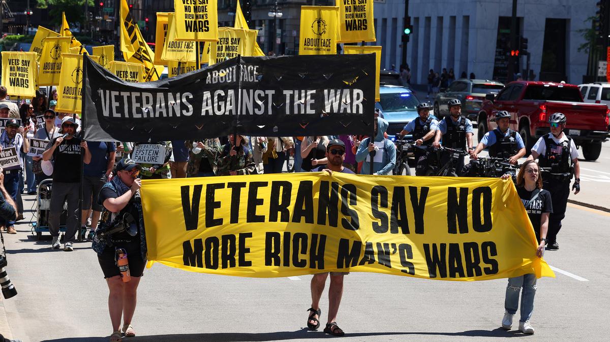 Navy veteran Alex Foss, from left, Army veteran Chris Gentry and National Guard veteran Kayla Harris march against the Iran war and President Donald Trump on Monday, May 25, 2026, in Chicago. (Stacey Wescott/Chicago Tribune/TNS)