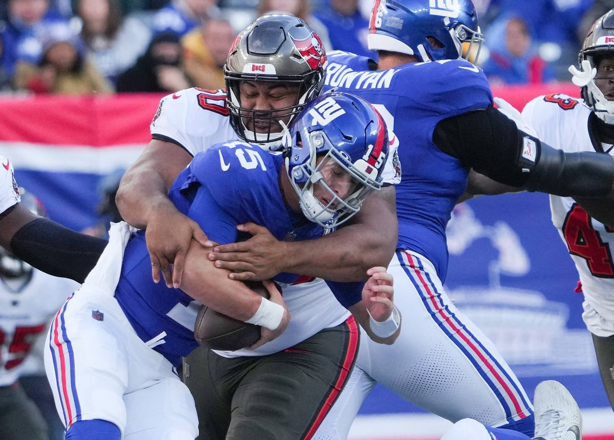 Nov 24, 2024; East Rutherford, New Jersey, USA; New York Giants quarterback Tommy DeVito (15) is sacked by Tampa Bay Buccaneers defensive tackle Vita Vea (50) during the first half at MetLife Stadium. Mandatory Credit: Robert Deutsch-Imagn Images
