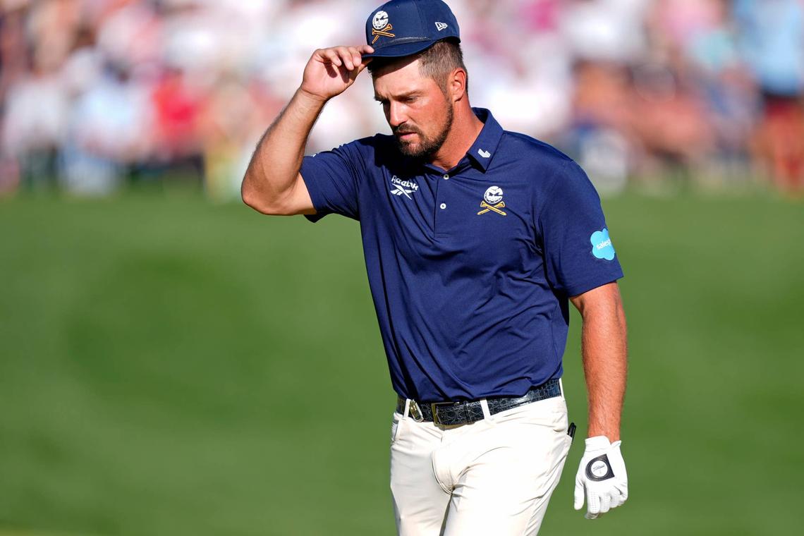  May 18, 2025; Charlotte, North Carolina, USA; Bryson DeChambeau acknowledges fans while walking on the 18th green during the final round of the PGA Championship golf tournament at Quail Hollow. Mandatory Credit: Jim Dedmon-Imagn Images 
