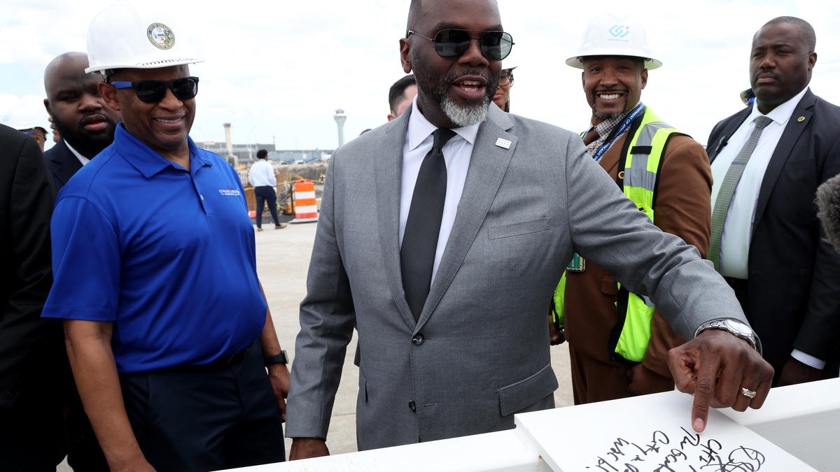 Mayor Brandon Johnson points to where he signed his name and wrote "The greatest frickin' city in the world!" at a ceremonial beam-signing event at the construction site of the new Concourse D project at O’Hare International Airport on April 23, 2026. (Antonio Perez/Chicago Tribune)
