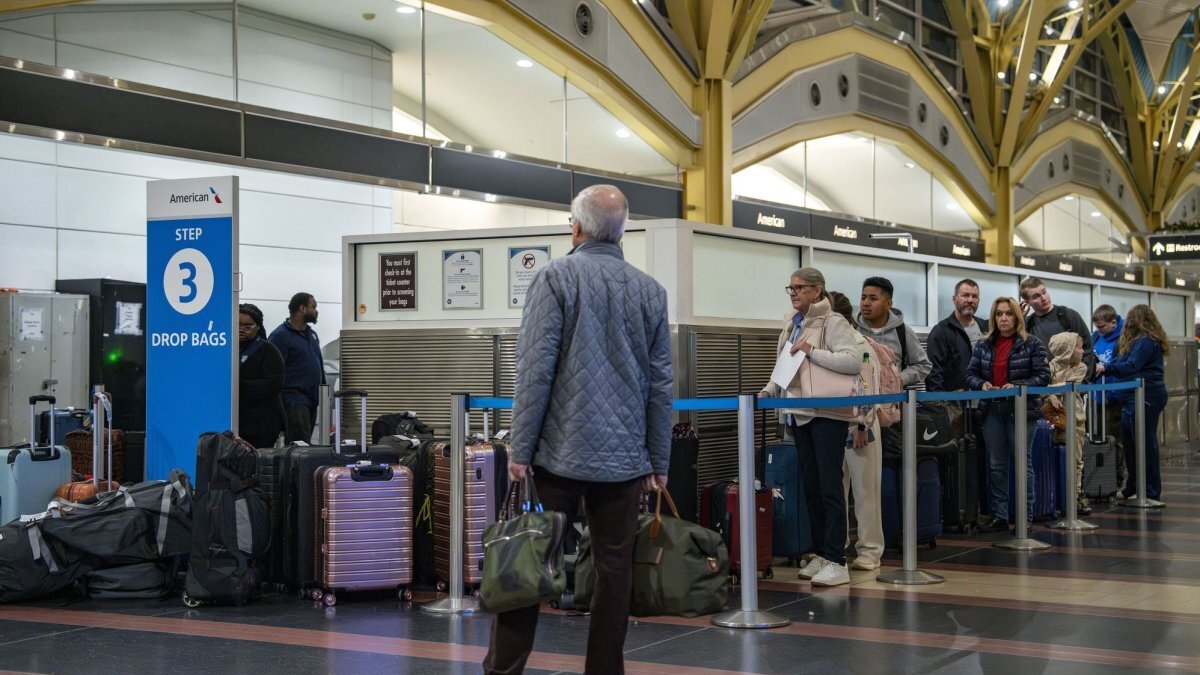 Passengers wait to drop their luggage while traveling during the holiday season at Ronald Reagan National Airport in Washington, D.C., on December 22. The airport is scheduled to close for most of July 4 to accommodate events celebrating Independence Day in the capital. File Photo by Bonnie Cash/UPI