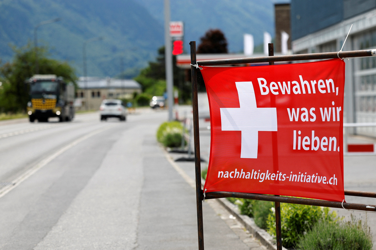 A sign is pictured ahead of a June 14 vote on a plan backed by the right-wing Swiss People's Party (SVP) to cap the population at 10 million inhabitants, in Glarus, Switzerland, May 18, 2026. The sign reads: "Preserve what we have". REUTERS/Stefan Wermuth