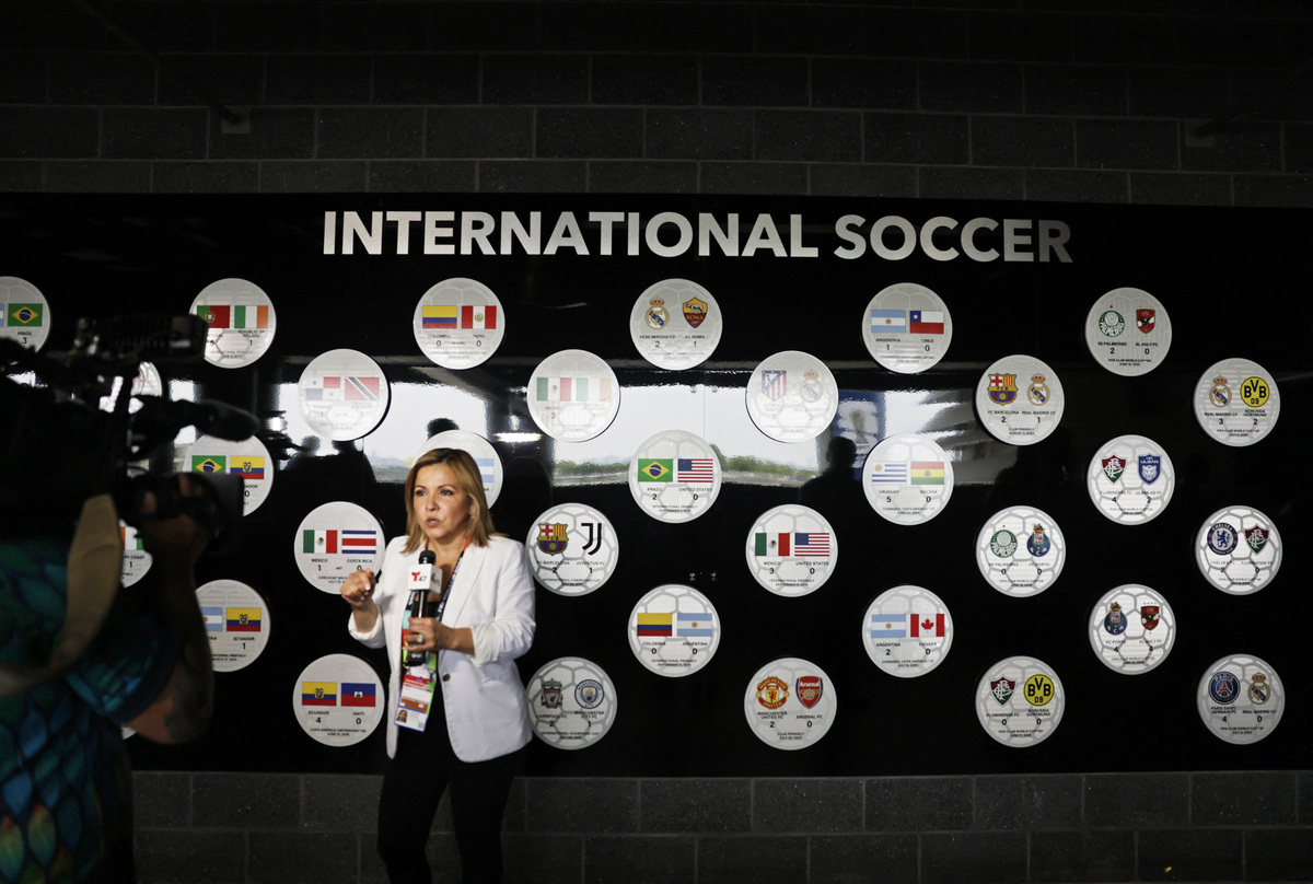 Soccer Football - FIFA World Cup 2026 - New York/New Jersey Stadium Tour - New York/New Jersey Stadium, East Rutherford, New Jersey, U.S. - June 10, 2026 General view of a member of the media stood in front of a wall commemorating past international football matches REUTERS/Jeenah Moon