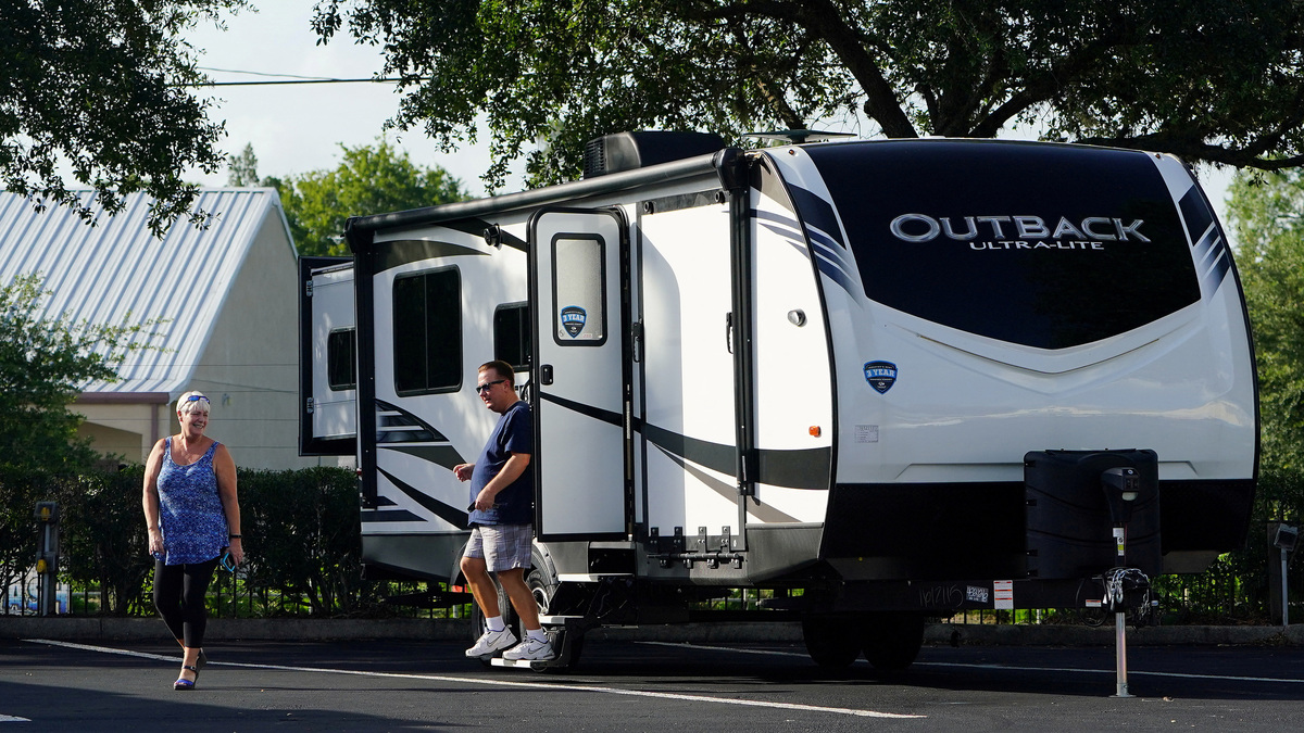 FILE PHOTO: People look at an RV for sale at a dealership in Dover, Florida, U.S., June 20, 2019.  REUTERS/Carlo Allegri/File Photo