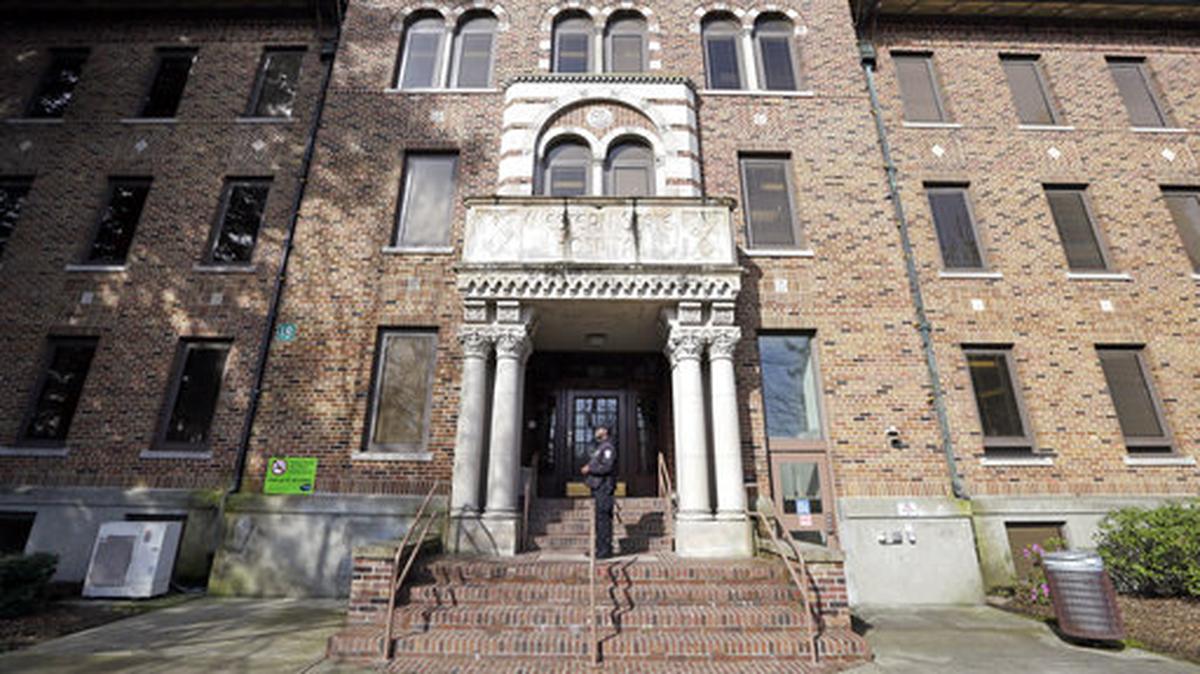 A security officer stands on steps at the entrance to Western State Hospital in Lakewood on April 11, 2017. A patient at the mental health facility seriously injured a staff member after punching and stomping on their head Sunday, according to Pierce County prosecutors.