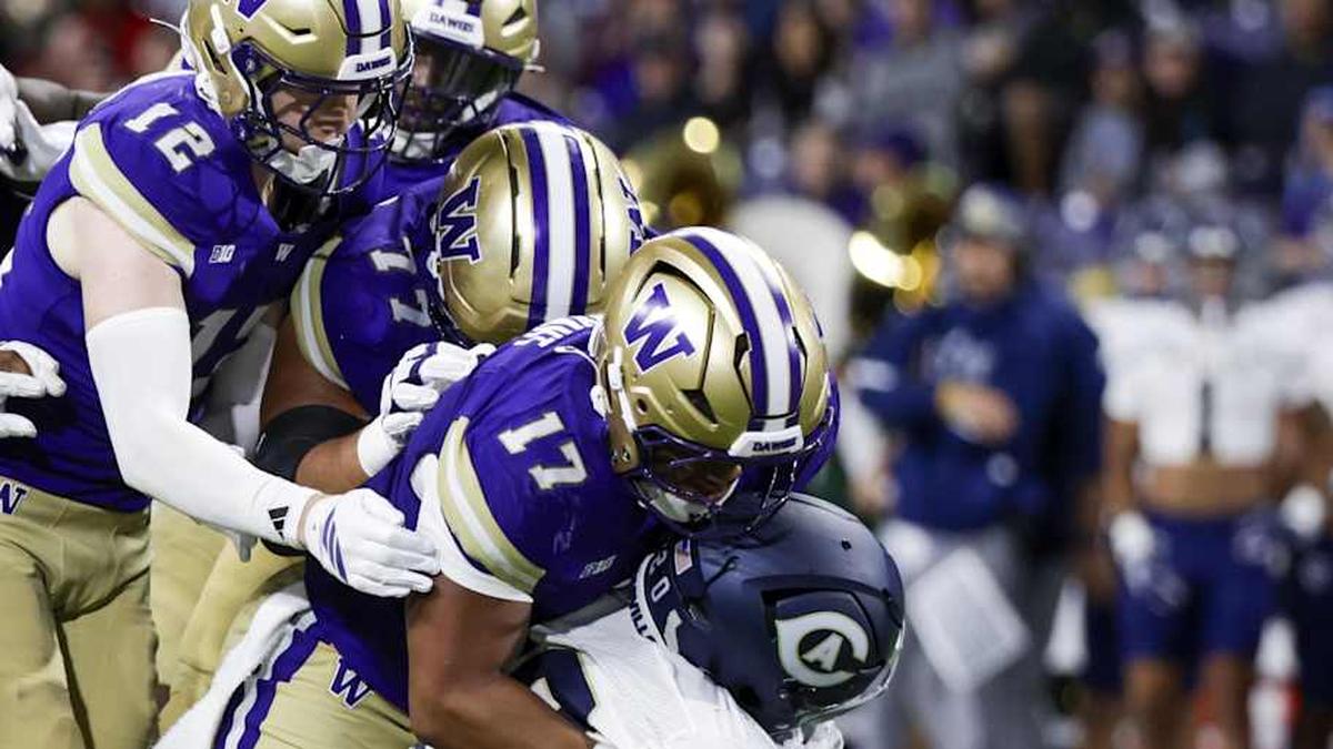  Sep 6, 2025; Seattle, Washington, USA; Washington Huskies linebacker Deven Bryant (17) tackles UC Davis Aggies running back Jordan Fisher (20) during the second quarter at Husky Stadium. Mandatory Credit: Joe Nicholson-Imagn Images | Joe Nicholson-Imagn Images 