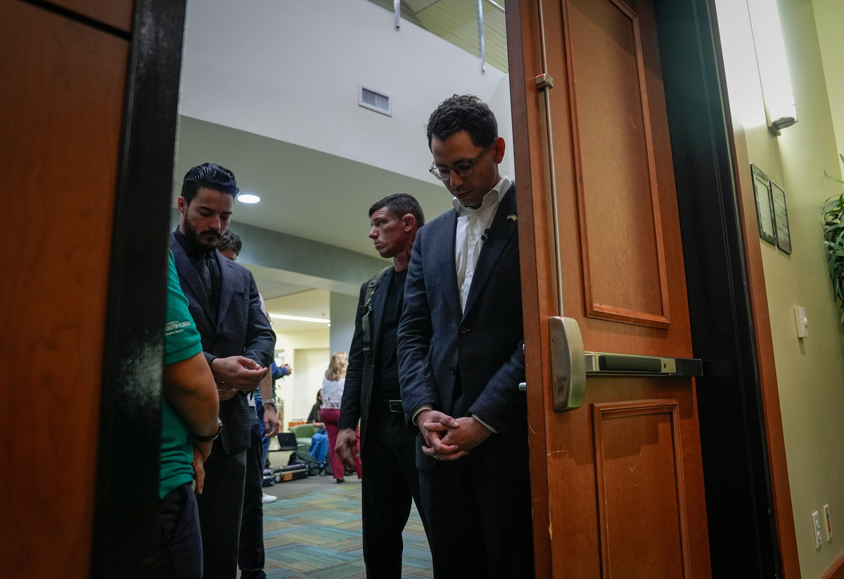 Florida Governor candidate James Fishback, right, waits to be introduced to speak at a campaign event at the Marshall Student Center at the University of South Florida in Tampa.