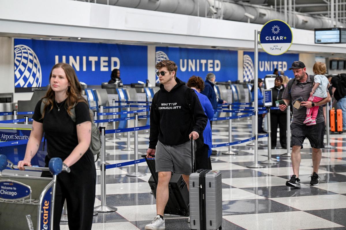 Passengers walk through the United Airlines terminal at Chicago O'Hare International Airport in Chicago, Illinois, U.S., April 14, 2026. REUTERS/Joshua Lott