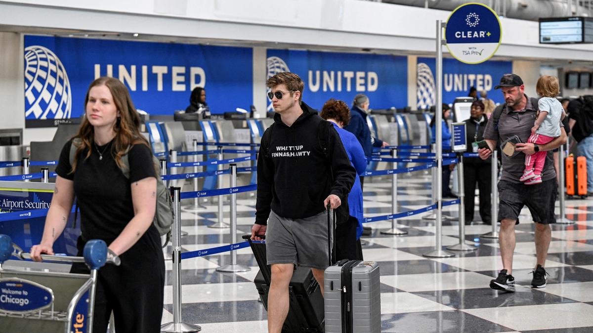 Passengers walk through the United Airlines terminal at Chicago O'Hare International Airport in Chicago, Illinois, U.S., April 14, 2026. REUTERS/Joshua Lott
