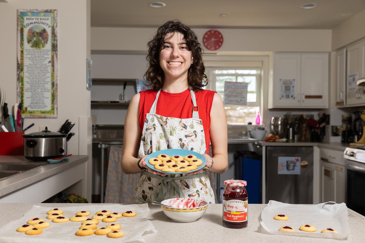 Annie Rogovin, a junior, with a batch of cookies at the Dacie Moses House, Carleton College's cookie house in Northfield, Minn., March 30, 2026. For decades, Carleton College has kept a place where students and others can come, bake and share. (Liam James Doyle/The New York Times)