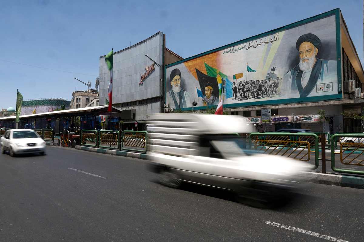 People drive past a mural depicting the late leader of the Islamic Revolution, Ayatollah Ruhollah Khomeini, and Iran's late Supreme Leader Ayatollah Ali Khamenei, on a street in Tehran, Iran, June 14, 2026. Majid Asgaripour/WANA (West Asia News Agency) via REUTERS