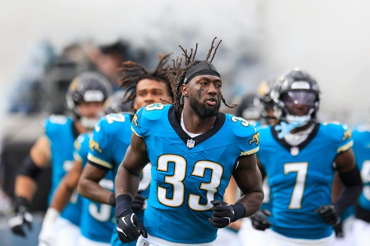 Jacksonville Jaguars linebacker Devin Lloyd (No. 33) runs onto the field before a game at EverBank Stadium in Jacksonville, Florida.