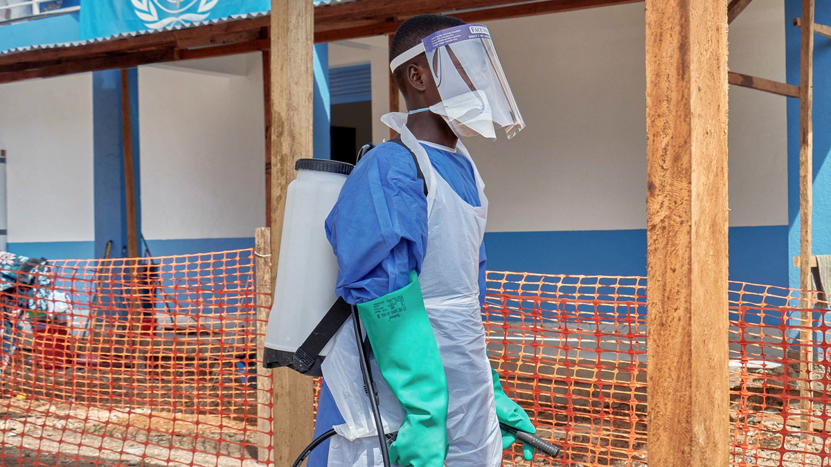 A Congolese medical worker walks at the Centre Medical Evangelique (CME) within the secured Ebola response zone, as aid agencies intensify efforts to contain the Ebola outbreak involving the Bundibugyo strain, in Hoho commune of Bunia town, Ituri province, Democratic Republic of Congo, June 9, 2026. REUTERS/Gradel Muyisa Mumbere