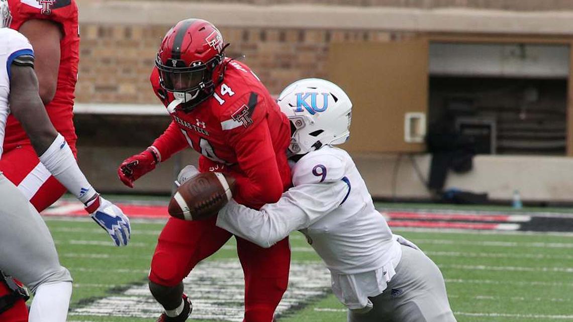 Dec 5, 2020; Lubbock, Texas, USA; Texas Tech Red Raiders running back Xavier White (14) rushes against Kansas Jayhawks defensive cornerback Karon Prunty (9) in the second half at Jones AT&T Stadium. Mandatory Credit: Michael C. Johnson-Imagn Images | Michael C. Johnson-Imagn Images 