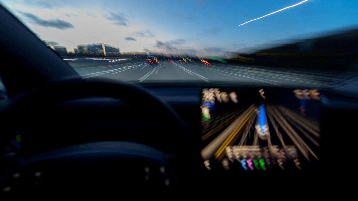 FILE PHOTO: A display of a Tesla Model 3 using Full Self-Driving Supervised on a highway in San Diego, California, U.S., April 15, 2026. Picture taken with a long exposure. REUTERS/Mike Blake//File Photo