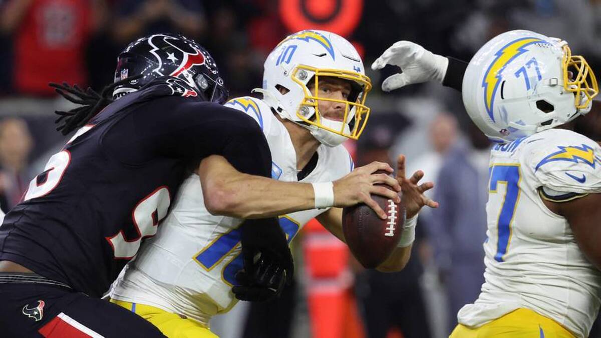  Jan 11, 2025; Houston, Texas, USA; Los Angeles Chargers quarterback Justin Herbert (10) is sacked by Houston Texans defensive end Denico Autry (96) during the third quarter in an AFC wild card game at NRG Stadium. Mandatory Credit: Troy Taormina-Imagn Images | Troy Taormina-Imagn Images 