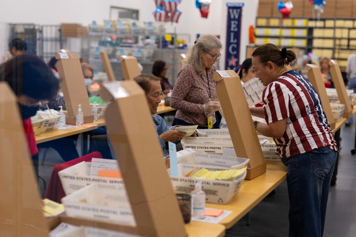 Election workers extract mail-in ballots at the registrar of voters' office during the California primary election in San Diego, California, U.S., June 2, 2026.  REUTERS/Mike Blake