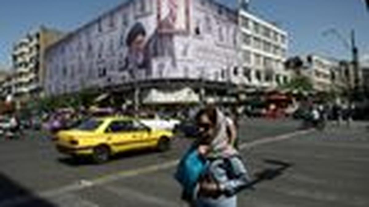 A woman walks near a billboard featuring an image of the late Supreme Leader of Iran, Ayatollah Ali Khamenei, in Tehran, Iran, May 11, 2026. Majid Asgaripour/WANA (West Asia News Agency) via REUTERS