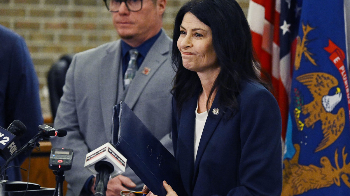 Michigan Attorney General Dana Nessel, Romulus, Mich., Mayor Robert McCraight and state Rep. Dylan Wegela (D-Garden City) during a news conference at Romulus City Hall in March 2026 to announce a lawsuit challenging ICE's conversion of the warehouse to a detention center. (Clarence Tabb Jr./The Detroit News/TNS)