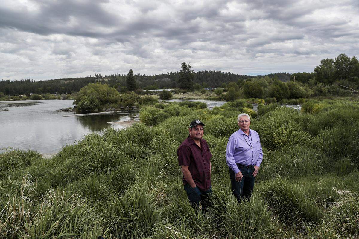 Council member Clayton Dumont, left, and tribal Chairman Don Gentry stand next to the Sprague River, which flows to Upper Klamath Lake. (Robert Gauthier/Los Angeles Times/TNS)