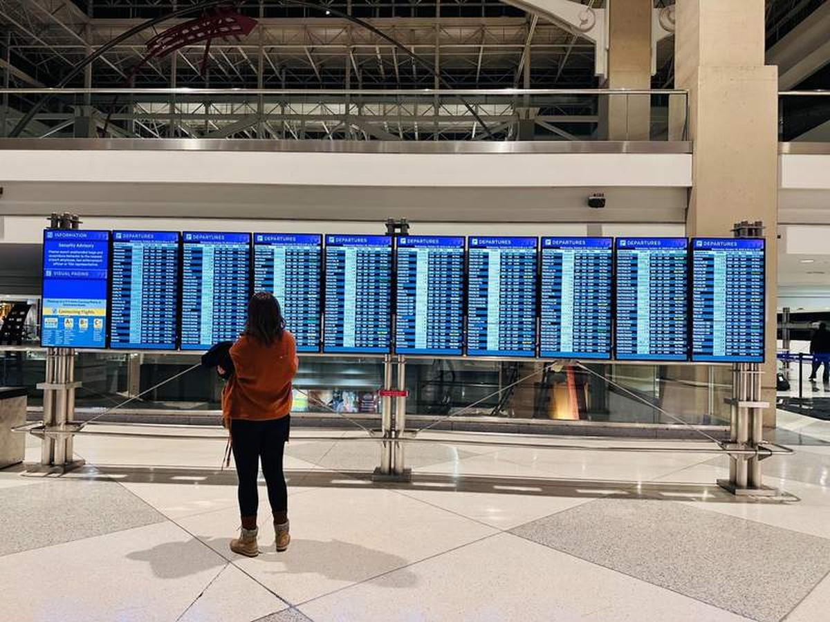  Standing in the airport looking at the incoming flights. Photo credit: Breeze Leonard 