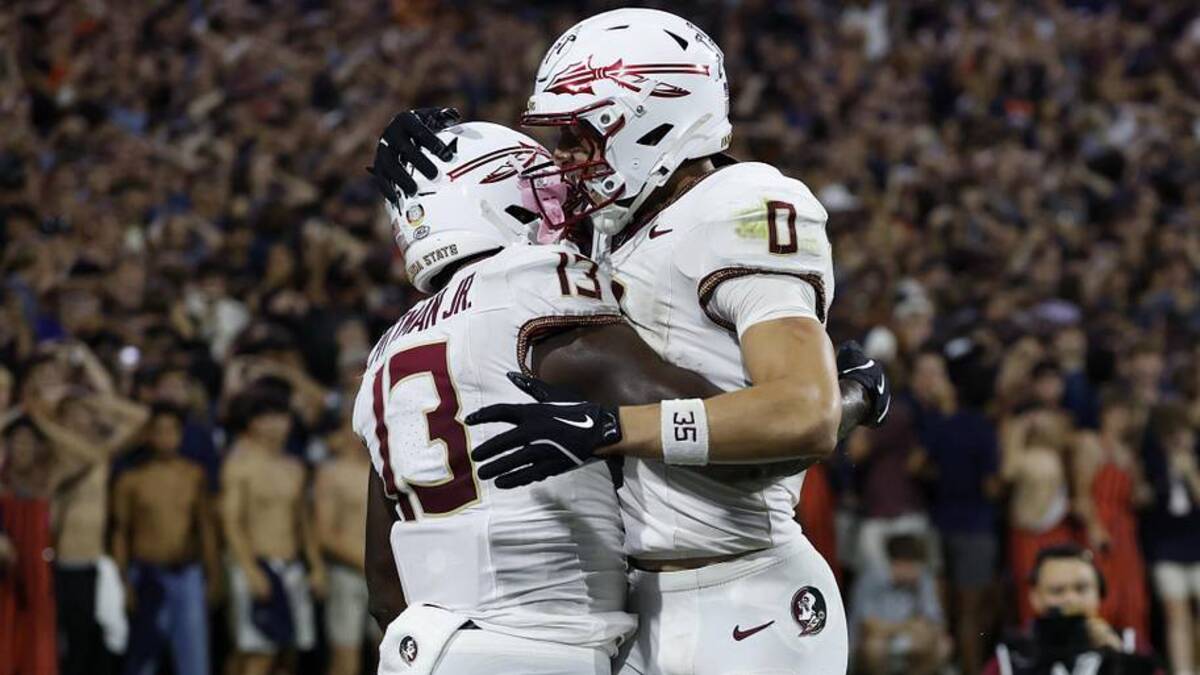  Sep 26, 2025; Charlottesville, Virginia, USA; Florida State Seminoles tight end Randy Pittman Jr. (13) celebrates with Seminoles wide receiver Duce Robinson (0) after catching a game tying touchdown pass in the final minute during the fourth quarter in front of Virginia Cavaliers linebacker Kam Robinson (5) during the fourth quarter at Scott Stadium. Mandatory Credit: Geoff Burke-Imagn Images | Geoff Burke-Imagn Images 