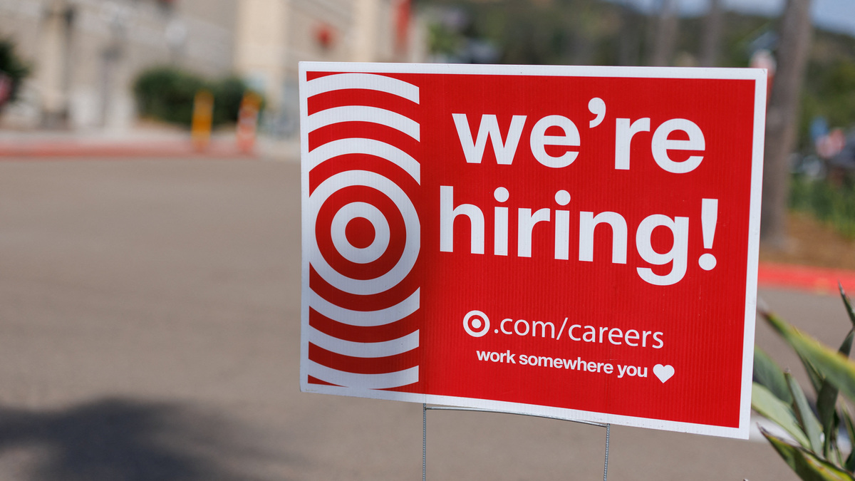 A "we're hiring" sign is displayed outside a Target store, after U.S. employment growth slowed more than expected in July,  in Encinitas, California, U.S. August 1, 2025.   REUTERS/Mike Blake