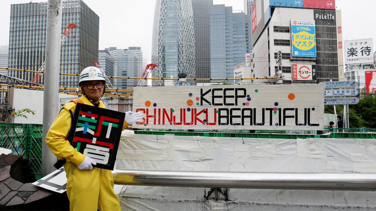 Shuetsu Sato, a security guard whose handmade duct-tape signs have gained widespread recognition, poses with duct-tape signs he made outside Shinjuku Station's east exit in Tokyo, Japan, May 1, 2026. REUTERS/Kim Kyung-Hoon