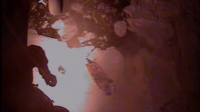 In a screengrab from a U.S Coast Guard video, an MH-60 Jayhawk helicopter aircrew from Coast Guard Air Station Kodiak rescues three adults and one child from an 18-foot vessel, right, that was trapped on an ice floe approximately 10 miles west of Chefornak, Alaska, on April 14, 2026. (U.S. Coast Guard/TNS)