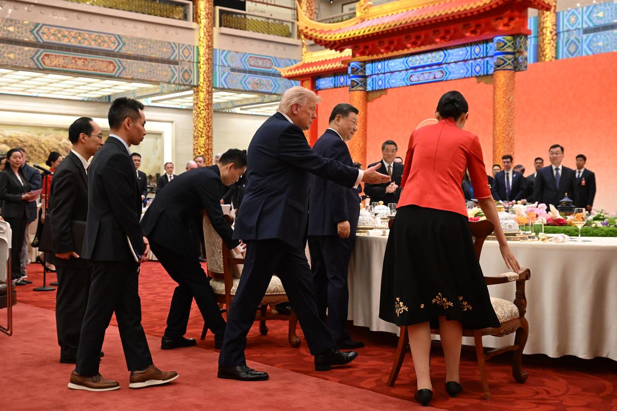 President Donald Trump and President Xi Jinping take their seats for state banquet at the Great Hall of the People in Beijing on Thursday, May 14, 2026. Crispy beef ribs, roast duck and tiramisu were on the menu Thursday at the state dinner, as Chinese chefs sought to appeal to Trump's culinary preferences while using traditional ingredients and cooking techniques. (Kenny Holston/The New York Times)..