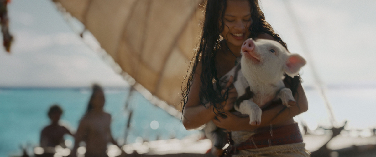 Moana (Catherine Laga'aia) cradles her beloved Pua in Disney's live-action "Moana."